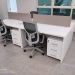 White color workstation desk with beige color acoustic partition.