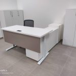 White height adjustable desk with brown panels and pedestals