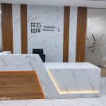 White and wooden finish reception desk in an office in Dubai.